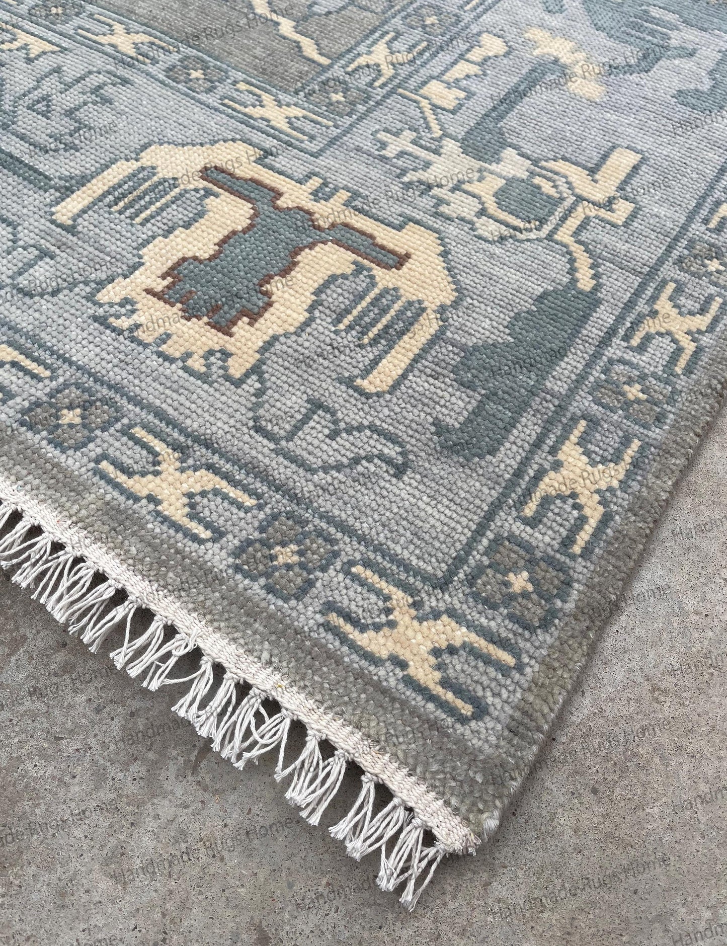 Handmade wool rug featuring Turkish inspired motifs and border