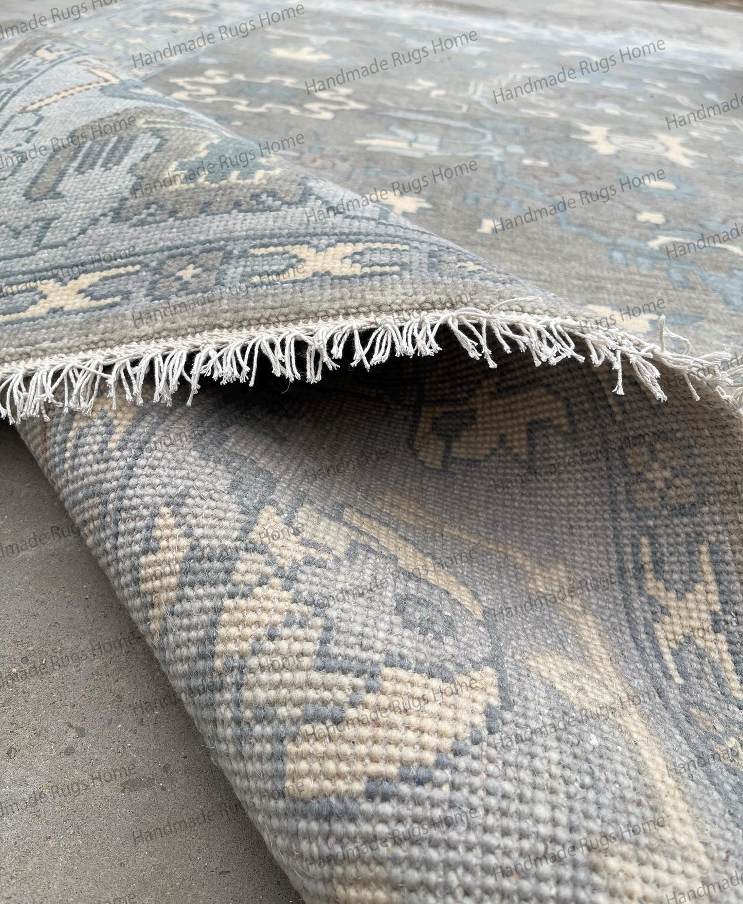 Artisan handmade grey and blue wool rug with detailed border design