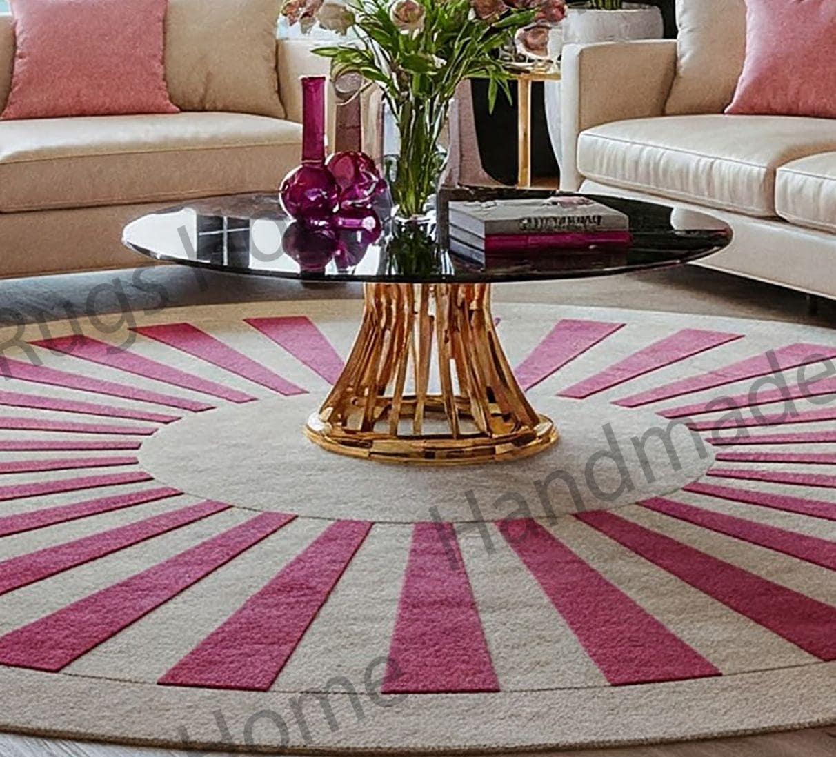 Round hand-tufted wool rug with pink radial pattern