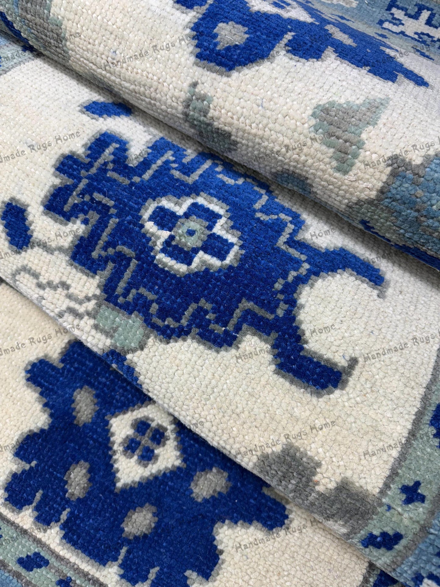 Traditional geometric patterned rug in shades of blue.