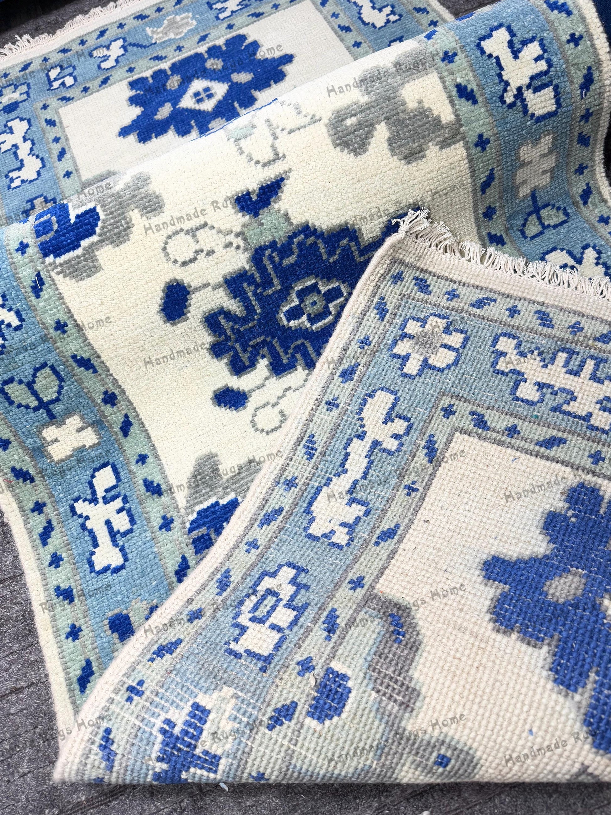 Handcrafted area rug with blue and grey accents.