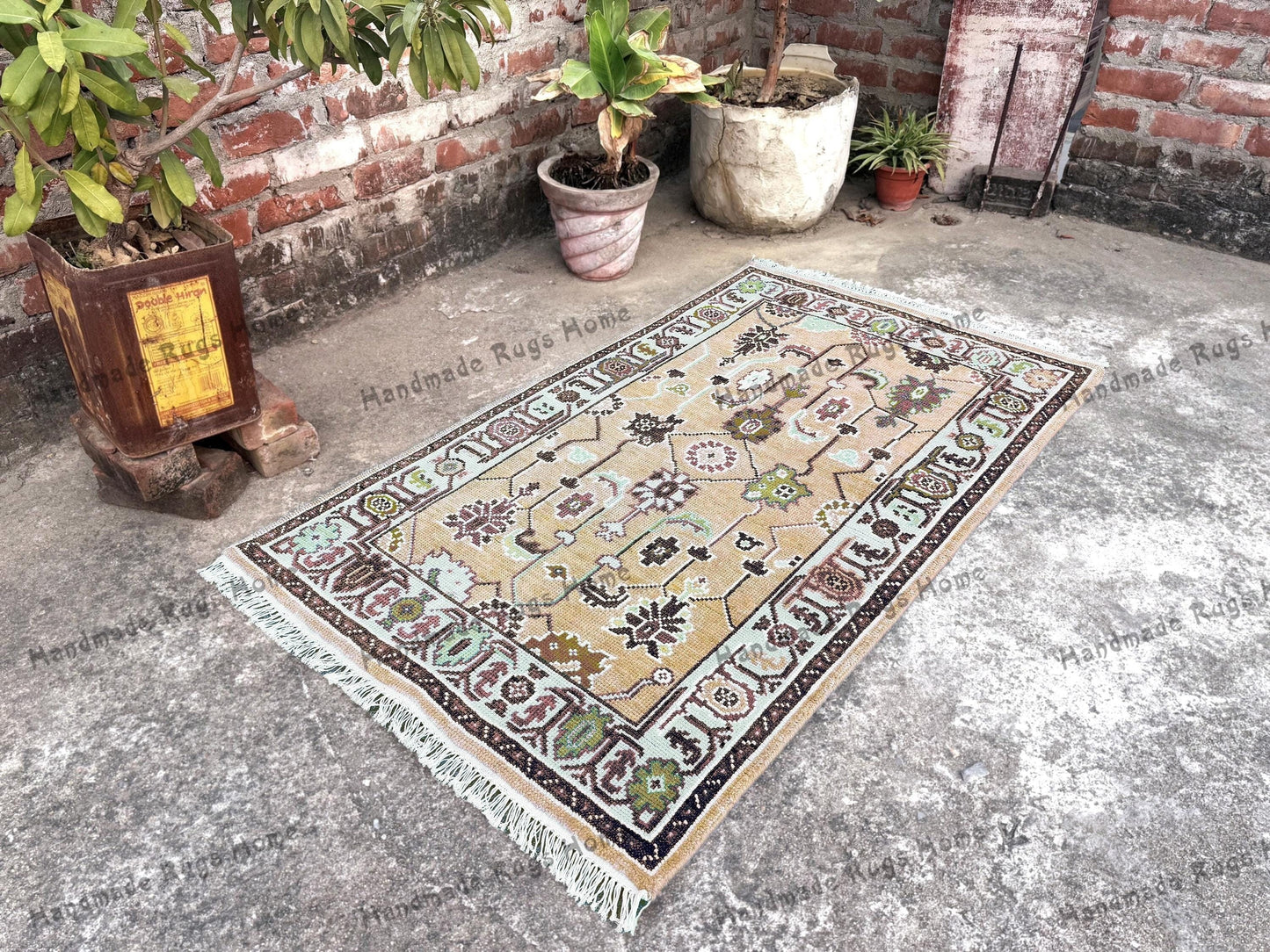 Oushak area rug with floral medallion designs in teal and pastel shades.