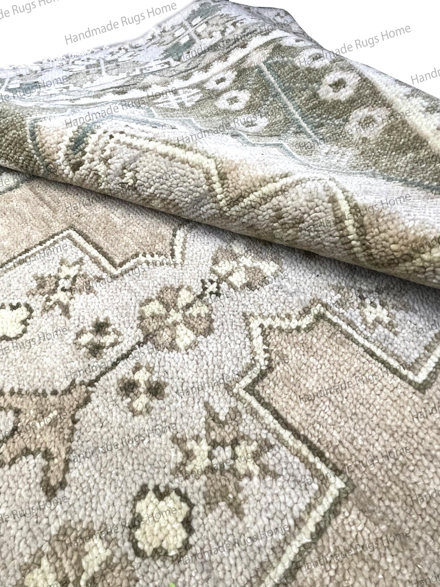 Detailed shot of the border and end pattern in rich taupe and dark gray colors.
