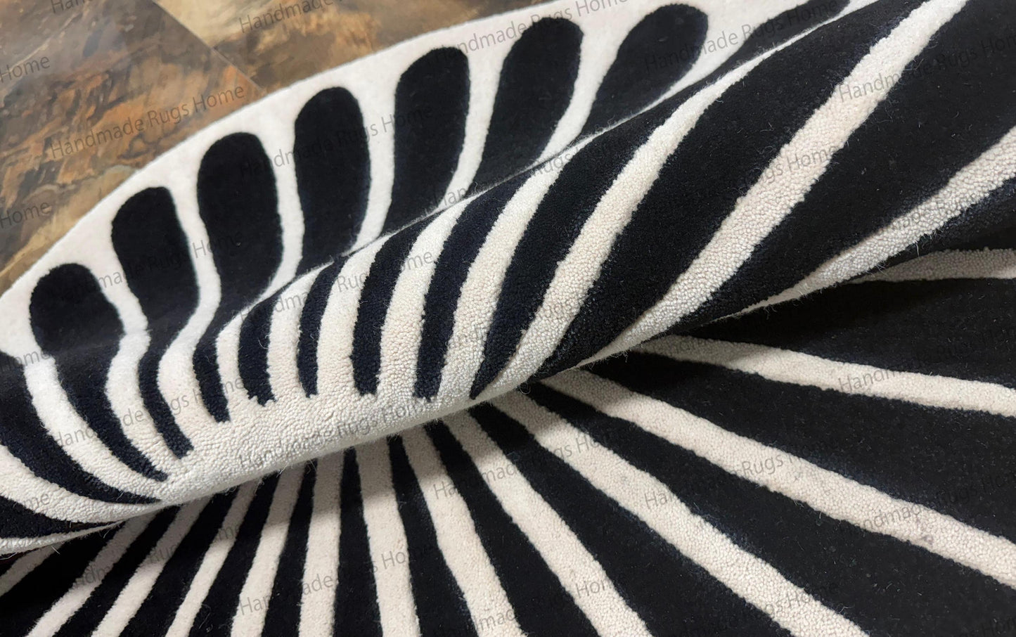 Art deco style round area rug for coffee table centerpiece,

Plush wool rug handmade with jet black tear drop shape,

Contemporary black spokes on white background floor mat.