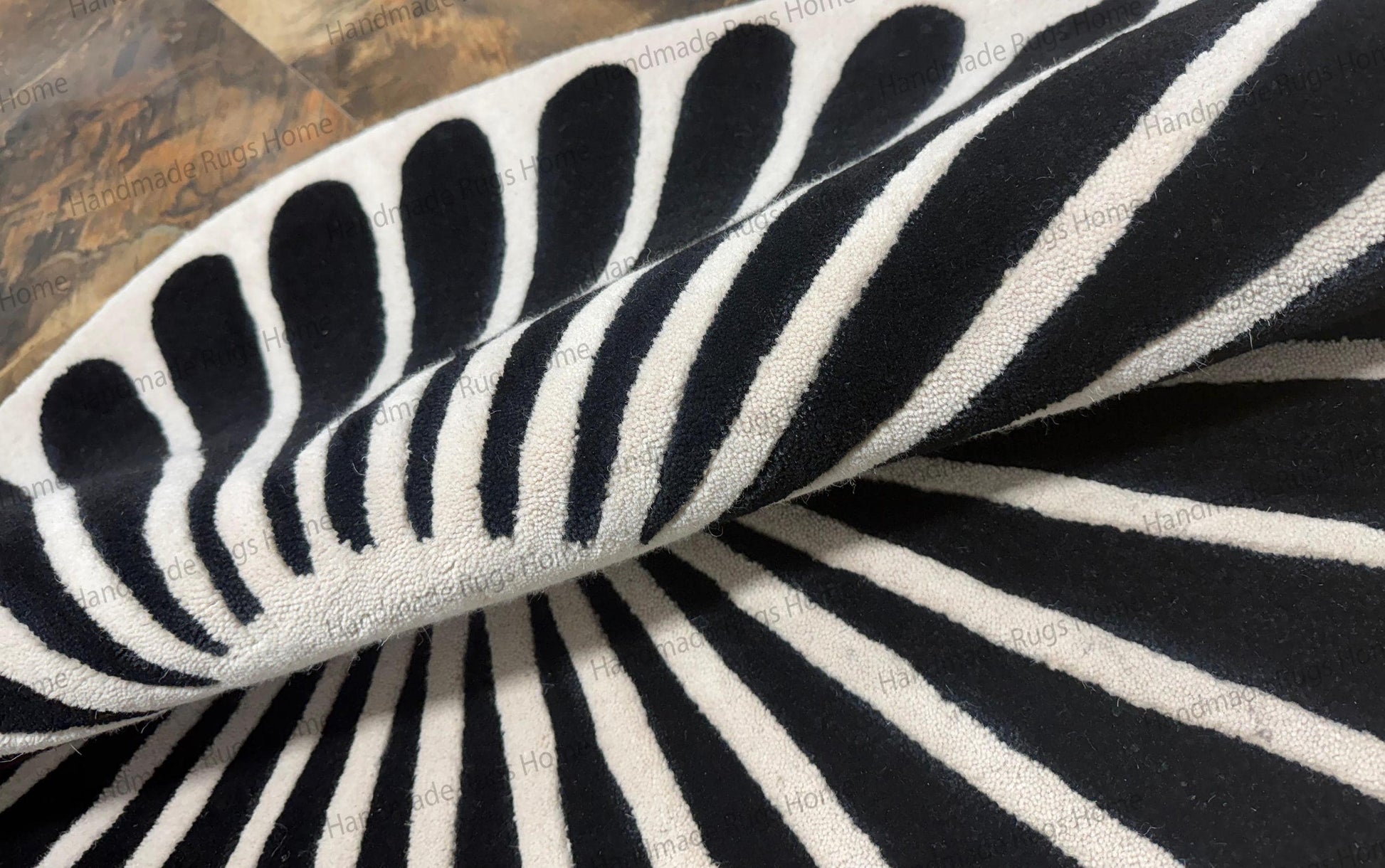 Art deco style round area rug for coffee table centerpiece,

Plush wool rug handmade with jet black tear drop shape,

Contemporary black spokes on white background floor mat.