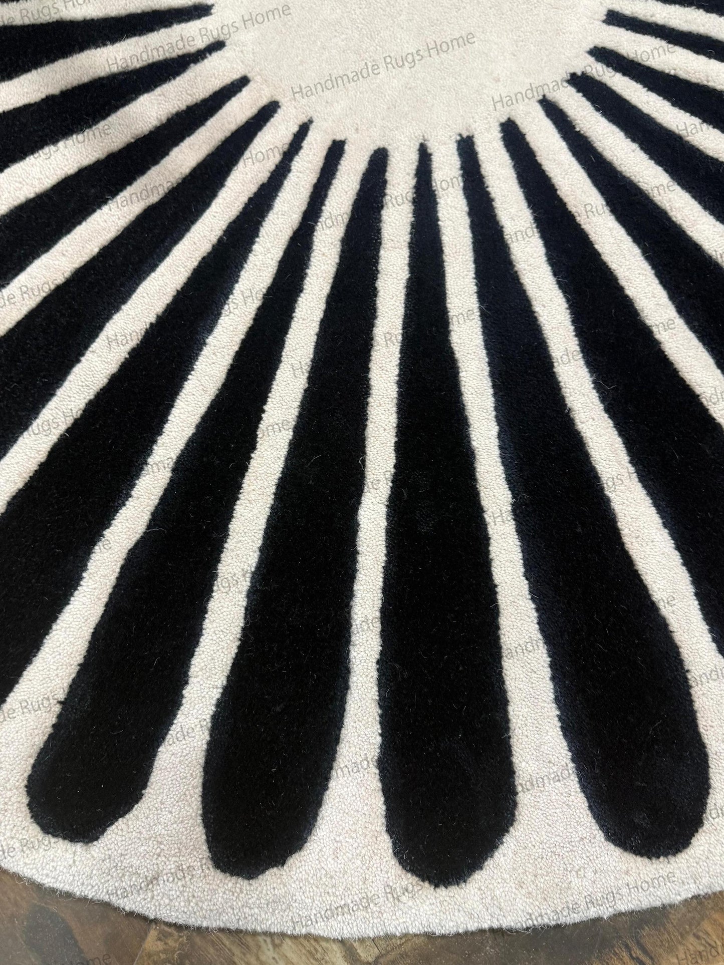 Scandi noir style wool mat for lounge area,

Geometric wheel pattern rug hand crafted,

Fashionable floor covering for boutique or office,

Soft underfoot bedroom rug black and white decor.