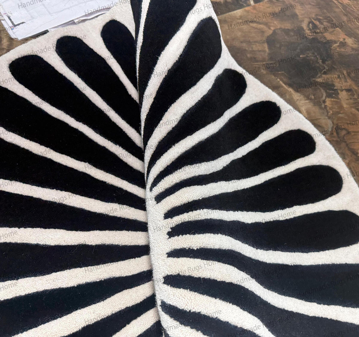Modern monochrome floor carpet with radiating black stripes.