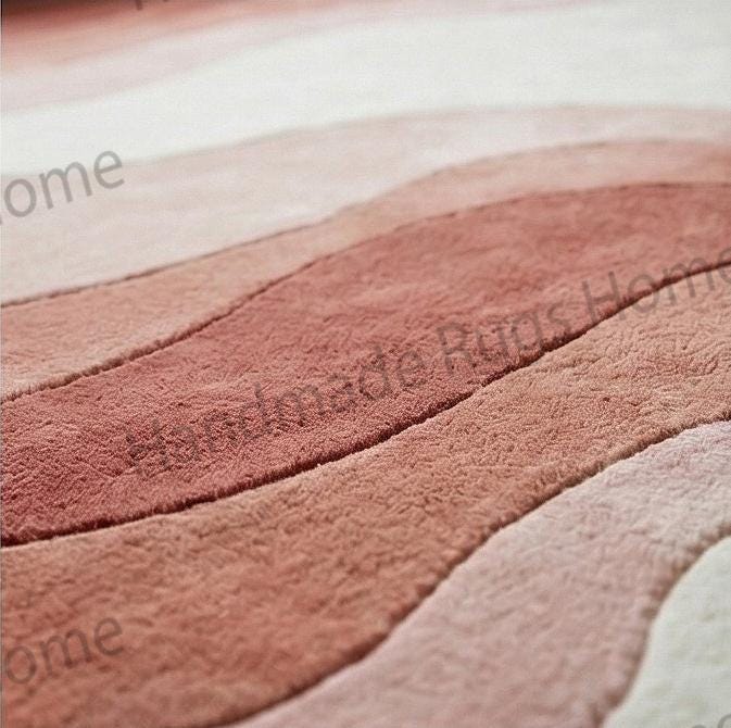 Gradient color palette rug mixing blush, terracotta, and ivory,

Dusty rose and rust orange tones in a gradient floor textile.