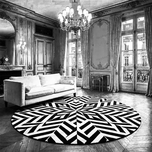 Modern black and white round hand tufted wool rug.