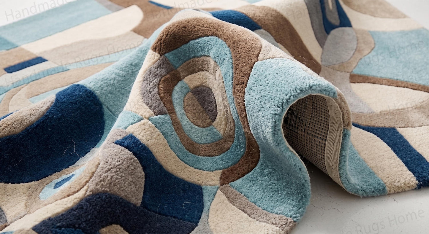 Durable handcrafted woolen mat for modern apartments.

Visual interest creating asymmetrical abstract floor layout.

Inviting warm and cool color contrast rug design.

Artisan-made tufted floor art showing dynamic movement.

Beautiful contemporary centerpiece carpet with distinct geometric zones.