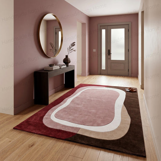 Abstract organic shaped hand tufted wool rug in red pink and brown

Fluid wavy design modern area rug featuring earthy tones

Contemporary asymmetric carpet with crimson cream and chocolate colors

Handcrafted plush floor covering showing irregular geometric patterns

Mid-century modern style textured rug highlighting blush and burgundy

Unique artisan made tapestry for living room flooring

Earthy palette bohemian aesthetic room decor piece

Curvilinear layered color block wool textile
