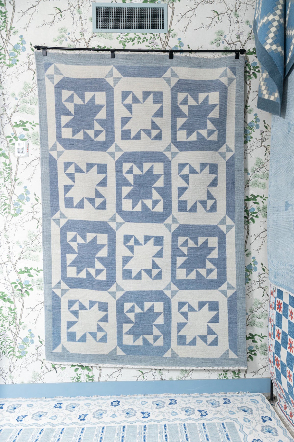 Modern Oushak blue and ivory geometric star rug displayed in a cottage-inspired interior